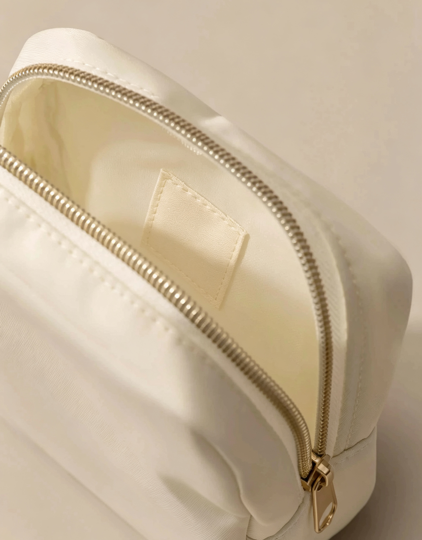 Soft Ivory Padded Clutch Bag with Polished Golden Metal Zip Fittings for Gentle Minimalist Daily Handheld Styling